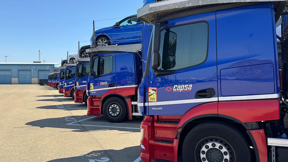 Car carrier trucks in logistics center 