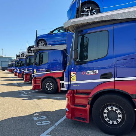 Car carrier trucks in logistics center 