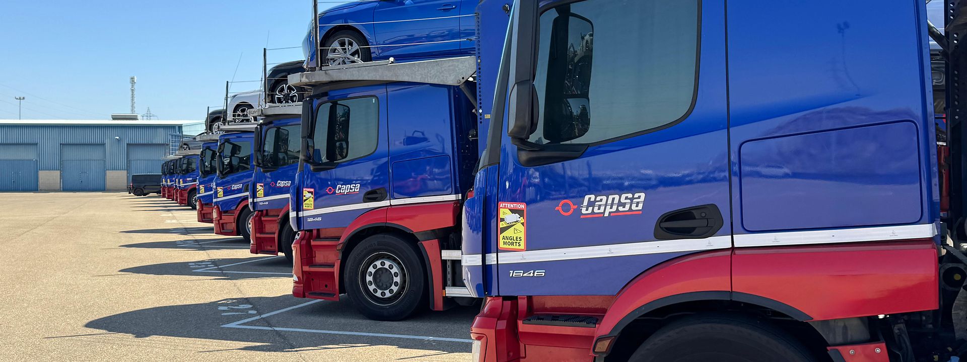 Car carrier trucks in logistics center 