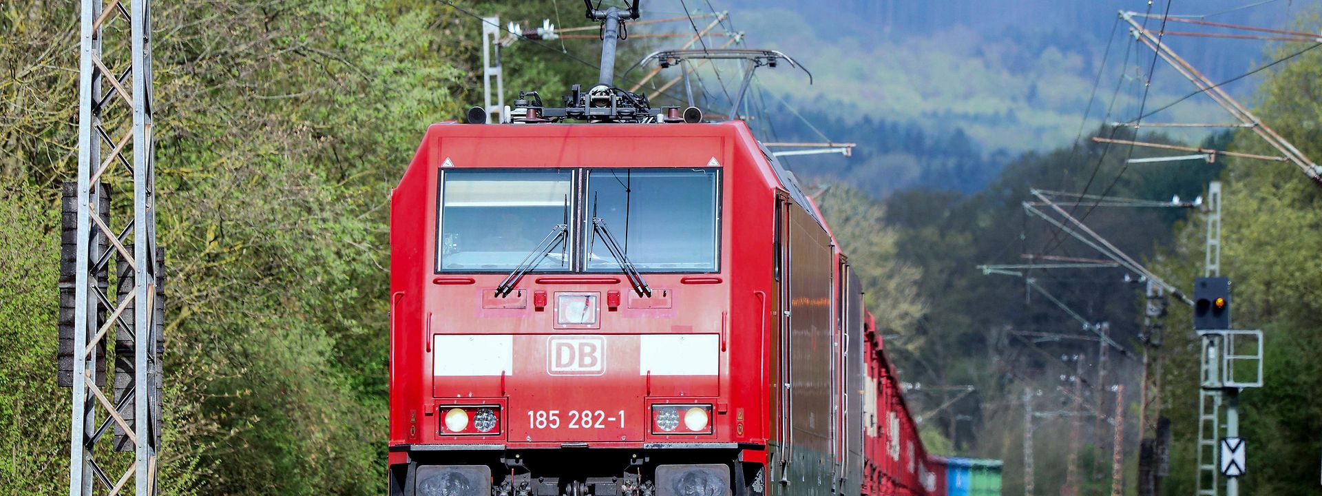 Freight train with green mountainous landscape 